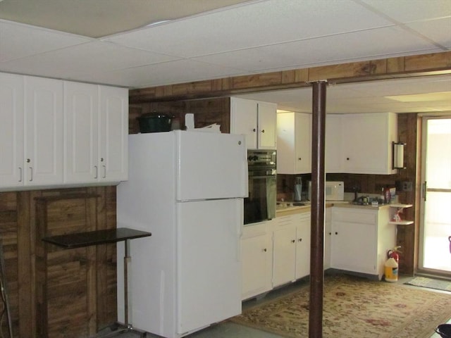 82 Laroche St, Ludlow, MA 01056 - kitchen with white appliances, white cabinetry, a drop ceiling, and plenty of natural light