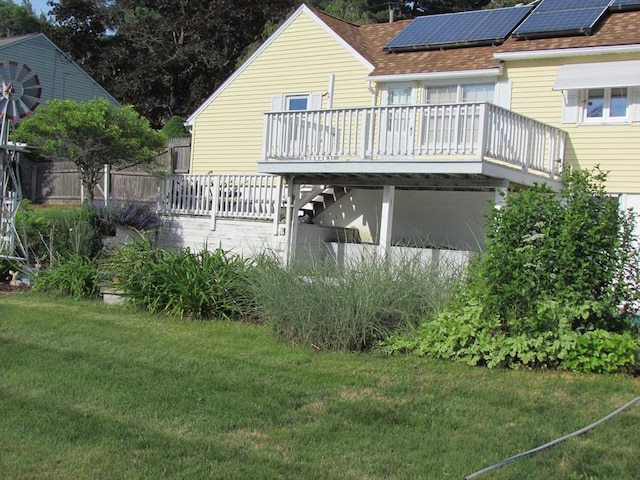 82 Laroche St, Ludlow, MA 01056 - rear view of property featuring a lawn, a wooden deck, and solar panels