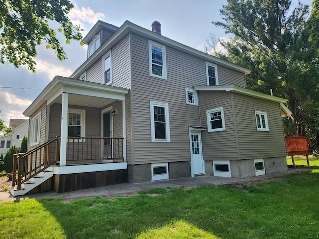 9 Varney St, Worcester, MA 01605 - rear view of property with a porch, a lawn, and a chimney