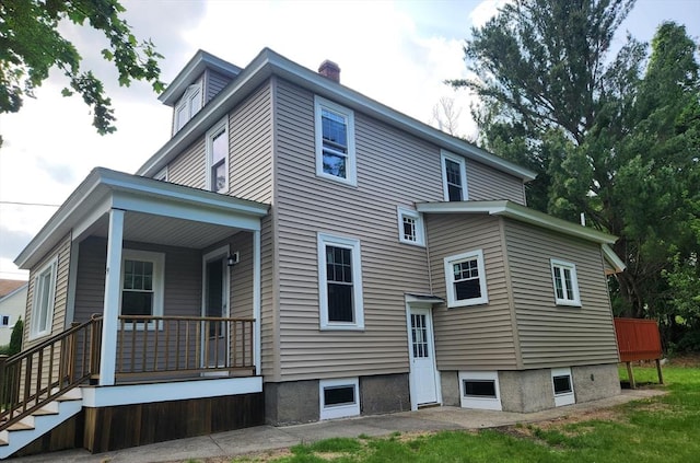 9 Varney St, Worcester, MA 01605 - rear view of house with a porch and a chimney