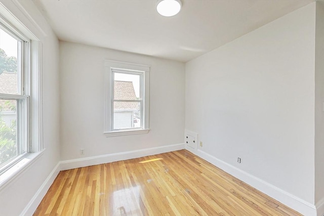 empty room featuring hardwood / wood-style flooring and a wealth of natural light