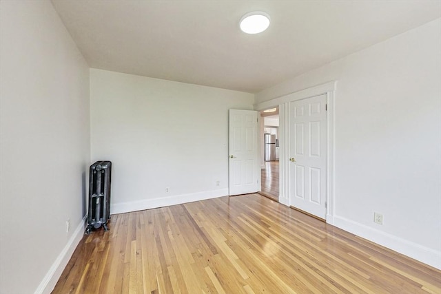 unfurnished room featuring hardwood / wood-style flooring