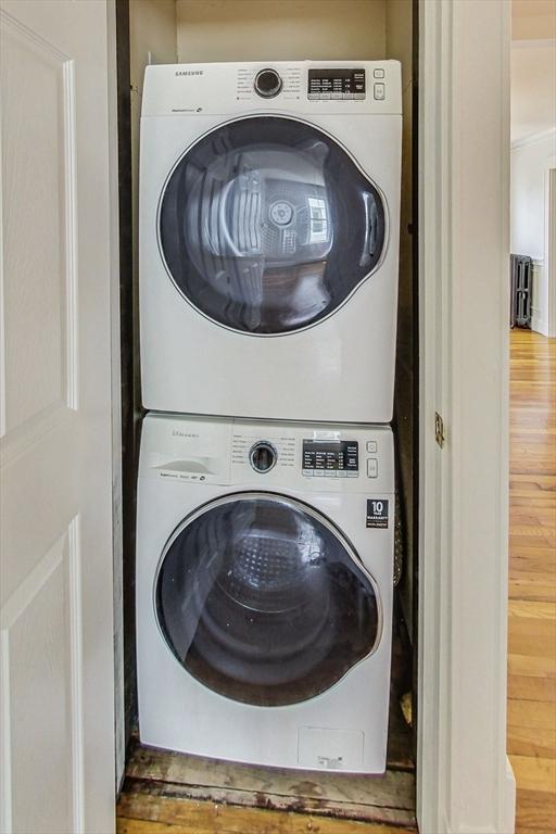 laundry area with stacked washing maching and dryer