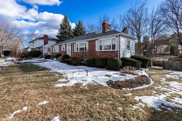 view of snowy exterior featuring a yard