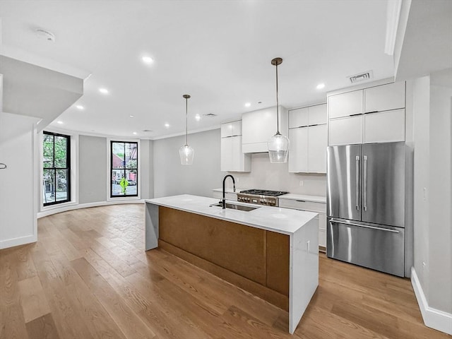667 Tremont St Unit 2, Boston, MA 02118 - kitchen with high end refrigerator, a sink, modern cabinets, white cabinetry, and light wood-type flooring