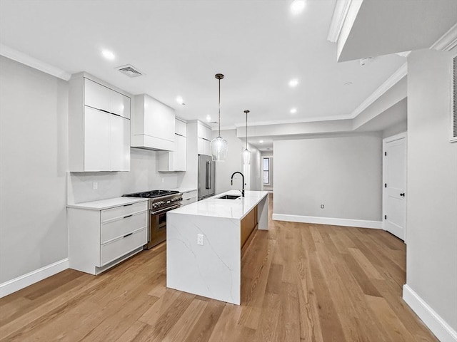 667 Tremont St Unit 2, Boston, MA 02118 - kitchen featuring high end appliances, a sink, crown molding, white cabinetry, and custom exhaust hood