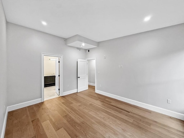 667 Tremont St Unit 2, Boston, MA 02118 - unfurnished bedroom featuring baseboards, light wood-style floors, recessed lighting, and ensuite bathroom