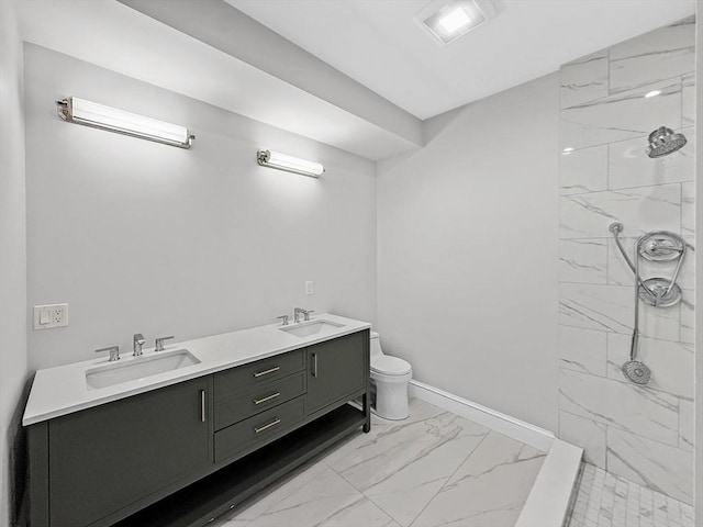 667 Tremont St Unit 2, Boston, MA 02118 - bathroom with marble look tiles, a marble finish shower, double vanity, baseboards, and toilet