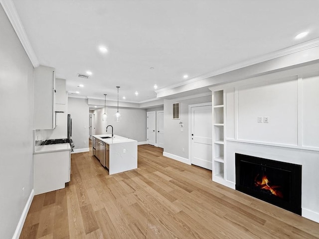 667 Tremont St Unit 2, Boston, MA 02118 - kitchen featuring crown molding, light countertops, recessed lighting, baseboards, and a lit fireplace