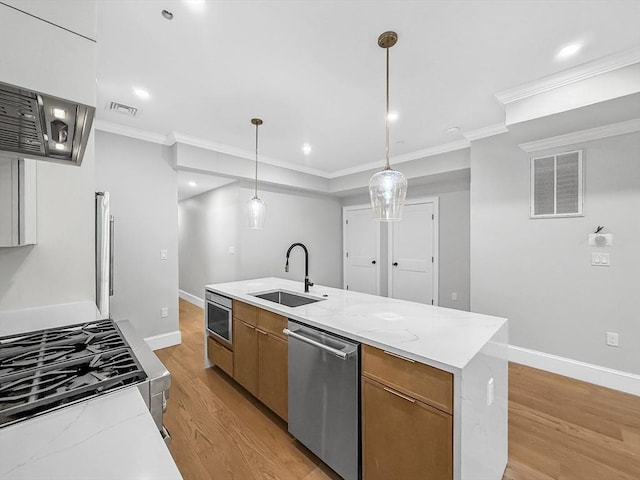 667 Tremont St Unit 2, Boston, MA 02118 - kitchen featuring appliances with stainless steel finishes, a sink, light wood-type flooring, ornamental molding, and brown cabinetry