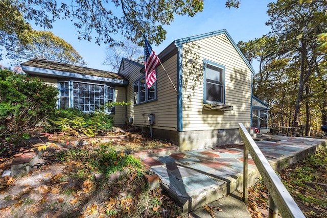 view of side of property featuring a patio