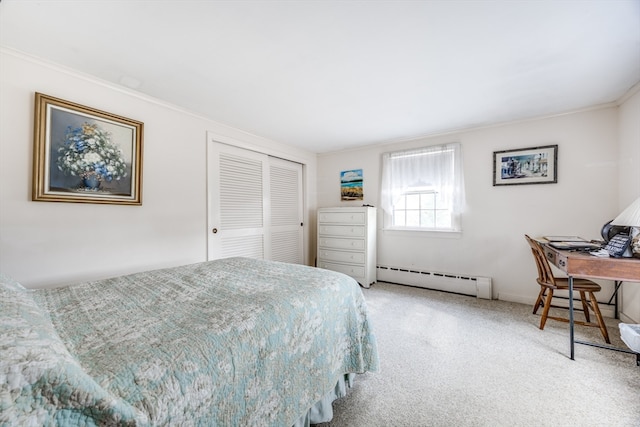 carpeted bedroom with crown molding, a closet, and a baseboard heating unit