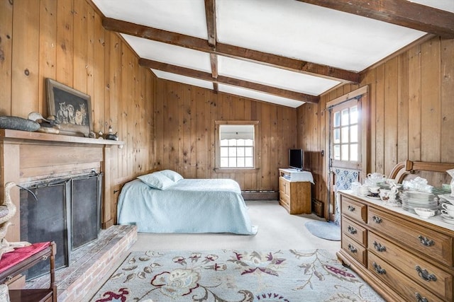 25 First Ave, Wellfleet, MA 02667 - bedroom featuring multiple windows, light carpet, wood walls, and a fireplace with raised hearth