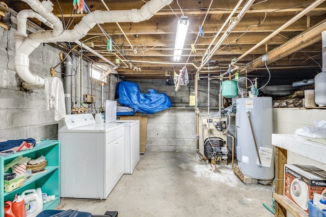 basement featuring electric water heater and washer and dryer