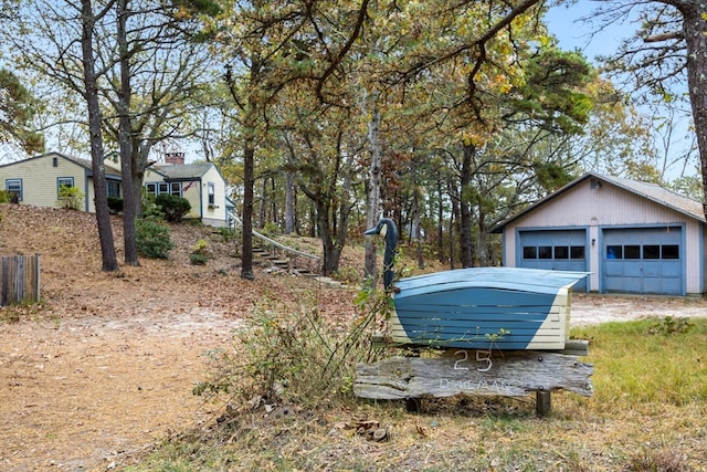 view of yard featuring a garage and an outdoor structure