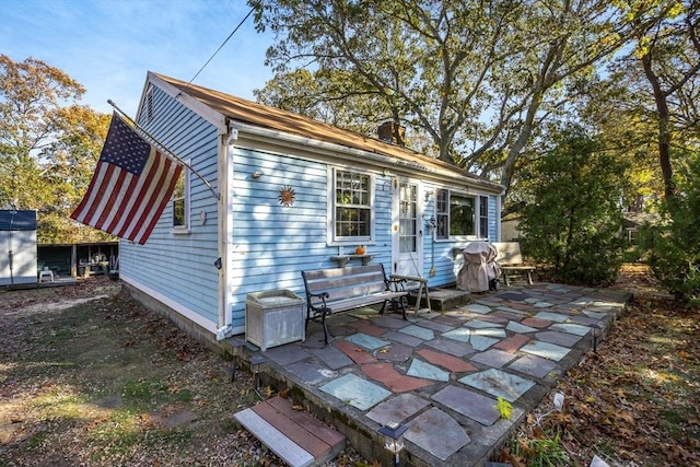 25 First Ave, Wellfleet, MA 02667 - rear view of house with a patio and a chimney