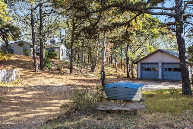 view of yard with a garage and an outdoor structure