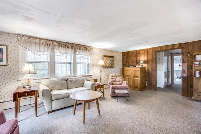 carpeted living room featuring wooden walls