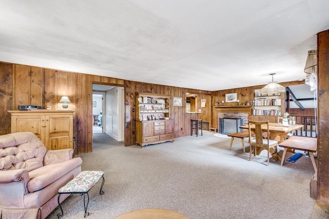 25 First Ave, Wellfleet, MA 02667 - carpeted living room with wood walls and a brick fireplace