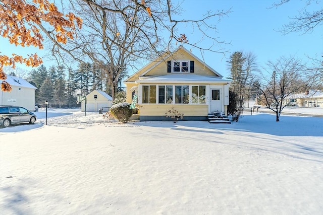 view of front of property featuring a garage and an outdoor structure