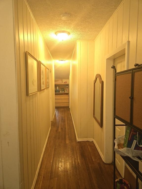88 Esmond St, Boston, MA 02121 - hallway featuring dark wood-type flooring and a textured ceiling