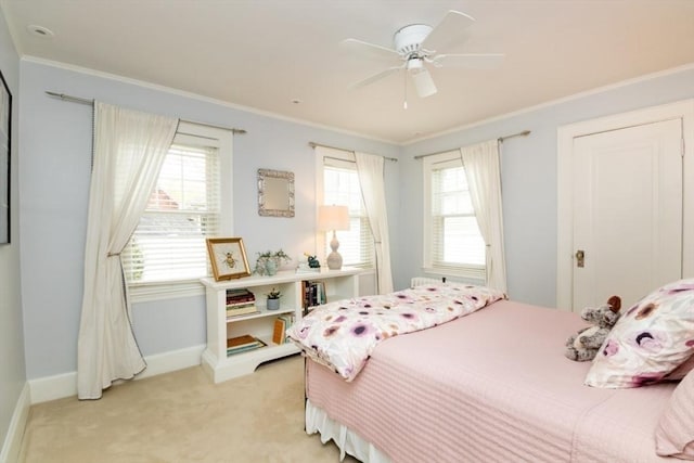 bedroom with baseboards, ornamental molding, multiple windows, and light colored carpet