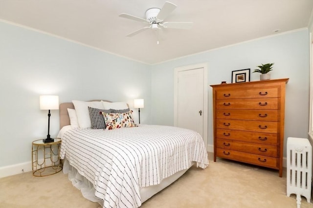 bedroom with radiator, ornamental molding, light carpet, and a ceiling fan