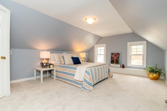 bedroom with carpet floors, baseboards, and vaulted ceiling