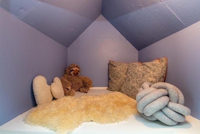 bedroom featuring carpet and vaulted ceiling