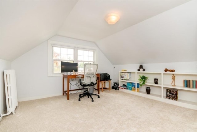 carpeted office with radiator and lofted ceiling