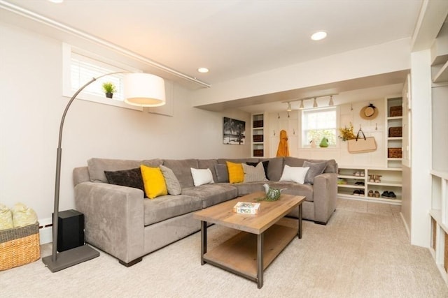 living room with recessed lighting and light carpet