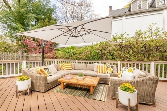 wooden terrace with fence and an outdoor living space