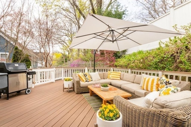 wooden terrace with an outdoor living space, a fenced backyard, and area for grilling