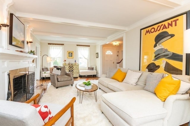 living room featuring crown molding, light wood finished floors, and a fireplace