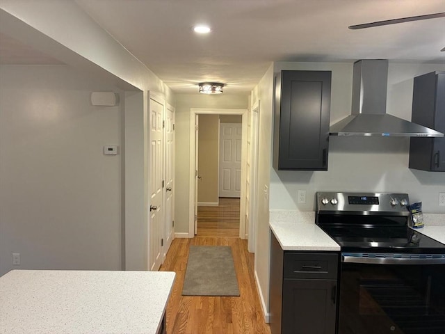 101 E Hadley Rd, Amherst, MA 01002 - kitchen with wall chimney range hood, electric stove, light wood finished floors, light countertops, and recessed lighting
