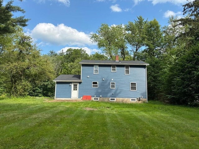 101 E Hadley Rd, Amherst, MA 01002 - rear view of house with a chimney, a yard, and a wooded view