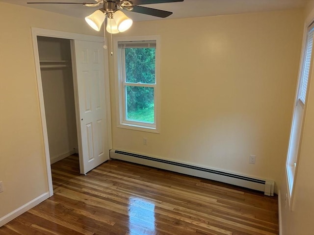 101 E Hadley Rd, Amherst, MA 01002 - unfurnished bedroom with a baseboard radiator, wood finished floors, a closet, and a ceiling fan
