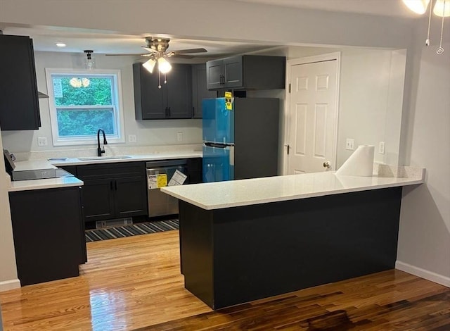 101 E Hadley Rd, Amherst, MA 01002 - kitchen with freestanding refrigerator, dishwasher, a peninsula, light wood finished floors, and light countertops