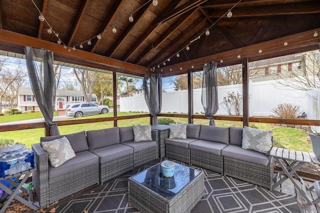 sunroom featuring an outdoor living space, a wealth of natural light, and beamed ceiling