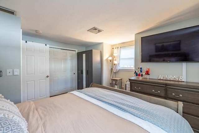 bedroom with visible vents and a closet