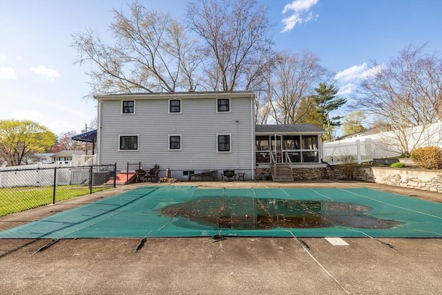 exterior space with a fenced backyard, a fenced in pool, and a sunroom