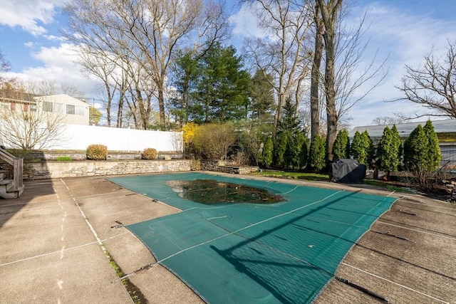 view of swimming pool featuring a fenced backyard, a fenced in pool, and a patio