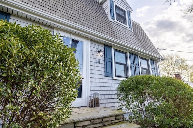 view of property exterior featuring a shingled roof