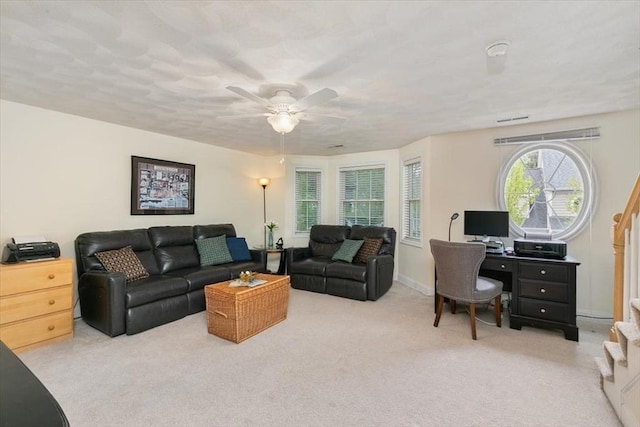 living room with carpet and a ceiling fan