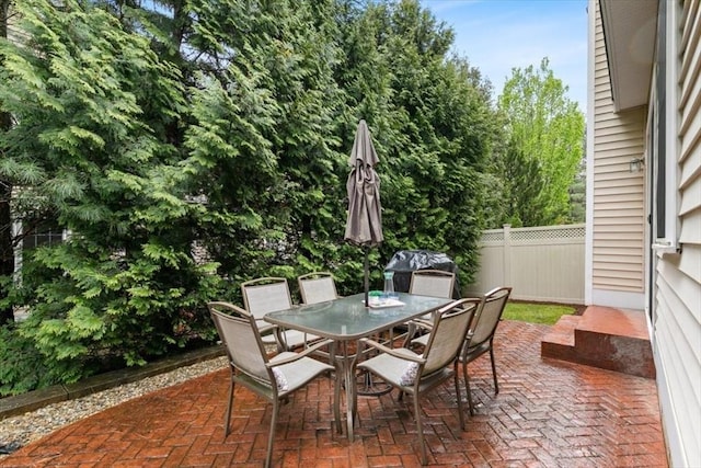 view of patio featuring fence and outdoor dining area