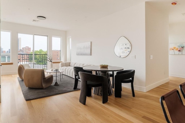58 Kent St Unit 404, Brookline, MA 02445 - dining space featuring light wood-style floors and baseboards