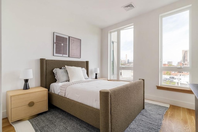58 Kent St Unit 404, Brookline, MA 02445 - bedroom with wood finished floors, baseboards, and a view of city