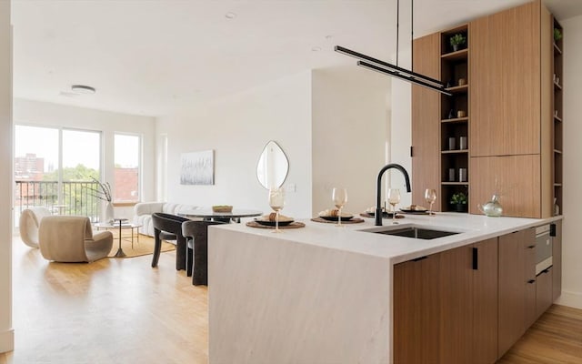 58 Kent St Unit 404, Brookline, MA 02445 - kitchen featuring a sink, modern cabinets, open shelves, and light countertops