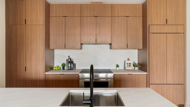 58 Kent St Unit 404, Brookline, MA 02445 - kitchen featuring stainless steel electric range oven, light countertops, paneled refrigerator, and modern cabinets