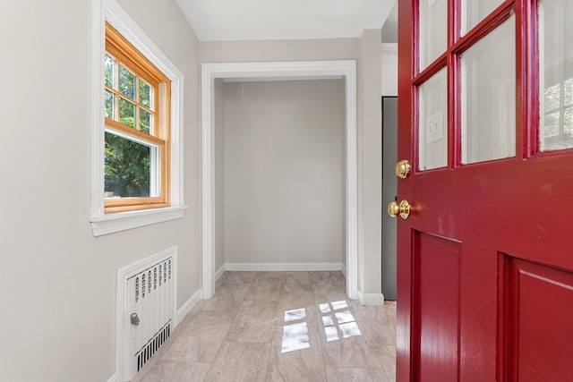 foyer featuring baseboards and radiator heating unit